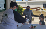 Monterey County (Calif.) Free Libraries staffer distributes food to patrons