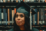 Woman wearing mortarboard in library (Photo: Clay Banks/Unsplash)