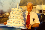 Herman Henry carrying the Johnson County, Indiana, sesquicentennial cake into the gala celebration in 1973 (Johnson County Museum Twitter)
