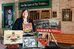 Lori Nyce, librarian at the National Toy Train Library in Ronks, Pennsylvania, stands behind display of photos and posters that are part of the library's collection