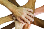 Various hands together symbolizing teamwork