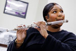 Lizzo playing a crystal flute