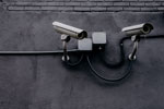 Two wall-mounted security cameras