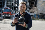 A man holding a Ukrainian rooster vase