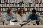 Teens reading books in library