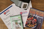 A high blood pressure medical kit with cuff, book, and DVD