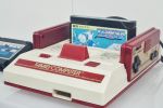 Red-and-white Nintendo Family Computer from the mid-80s, with a cartridge for the game Xevious in its cartridge slot