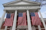Public library building draped with US flags