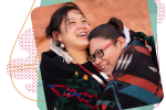 Two Indigenous girls hugging.