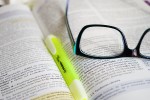 Pair of glasses and a highlighter on a book