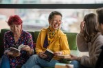 A woman laughing at a book club