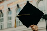 Hand holding graduation cap