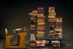 Desk with stacks of books in front of it