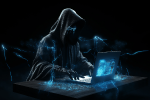 Hooded figure using a computer in the dark