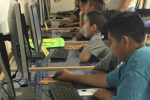 Youth library patrons accessing internet at a library in the Middle Rio Grande Pueblo Tribal Consortium, a Tribal library & school fiber network supported in part by E-Rate funds.