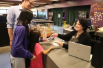 Stock photo of library patrons at a service desk from Winter Park Library's stock photo day.