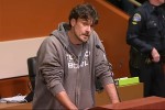 Chris Kluwe speaking into a microphone atop a podium