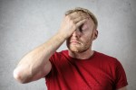 Stressed man with his head in his hand