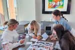 Four students work through an activity with a digital countdown clock in the background.