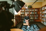 Woman being interviewed in front of bookshelves