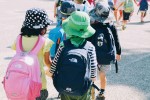 Young students walking wearing backpacks