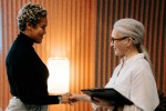 Two women shaking hands in an office setting