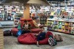 Kids on cushions reading in a library