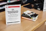Sign at Seattle Public Library asking patrons to keep their books while the library was facing a cyberattack.