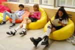 Three kids sitting on beanbag chairs