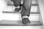Close-up of a person's feet walking down stairs