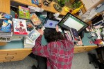Librarian with his head on his desk after cataloging more than 200 graphic novels