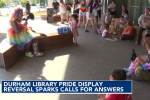 Drag performer reading to kids outside Durham Library