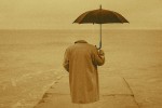 Invisible person in a trenchcoat holding an umbrella