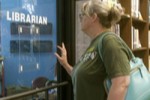 Screen cap from The Librarians depicting a woman approaching a librarian's office