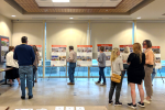 Patrons examine plans for a library renovation at a public meeting
