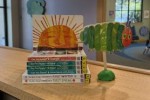 Withdrawn board books used as art supplies for a puppet