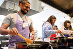 Person stirring a pot at a stove